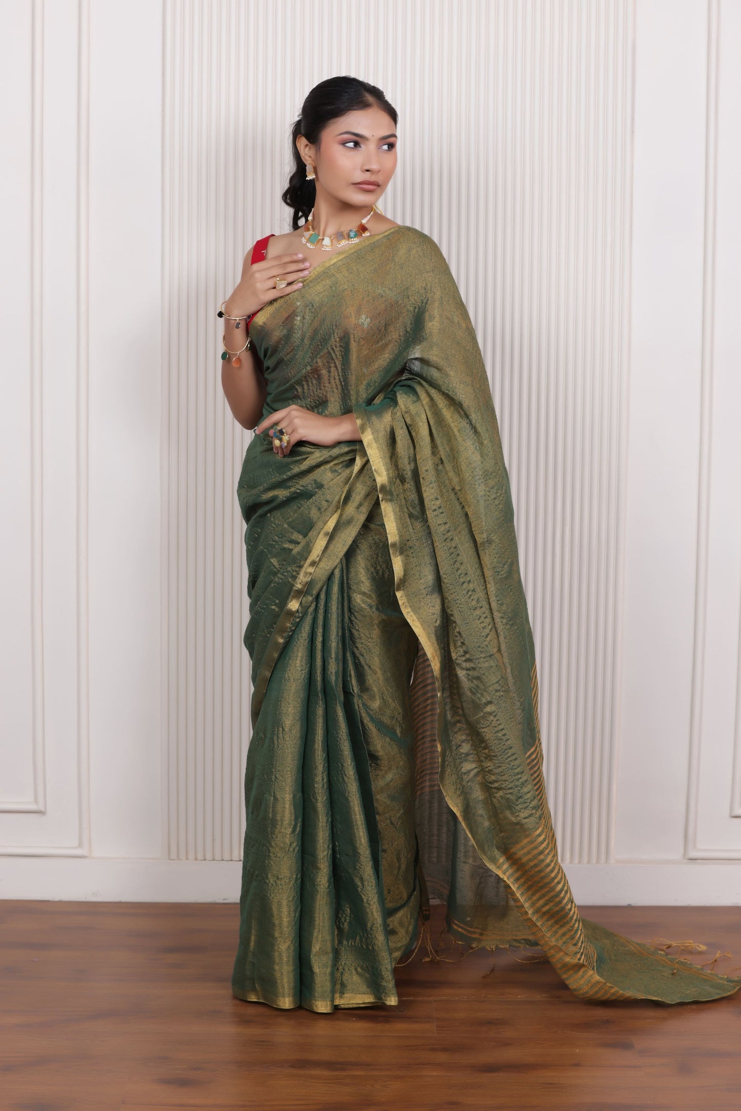LUXE GREEN LINEN TISSUE SAREE WITH LUSTROUS ZARI STRIPES AND REFINED DRAPE