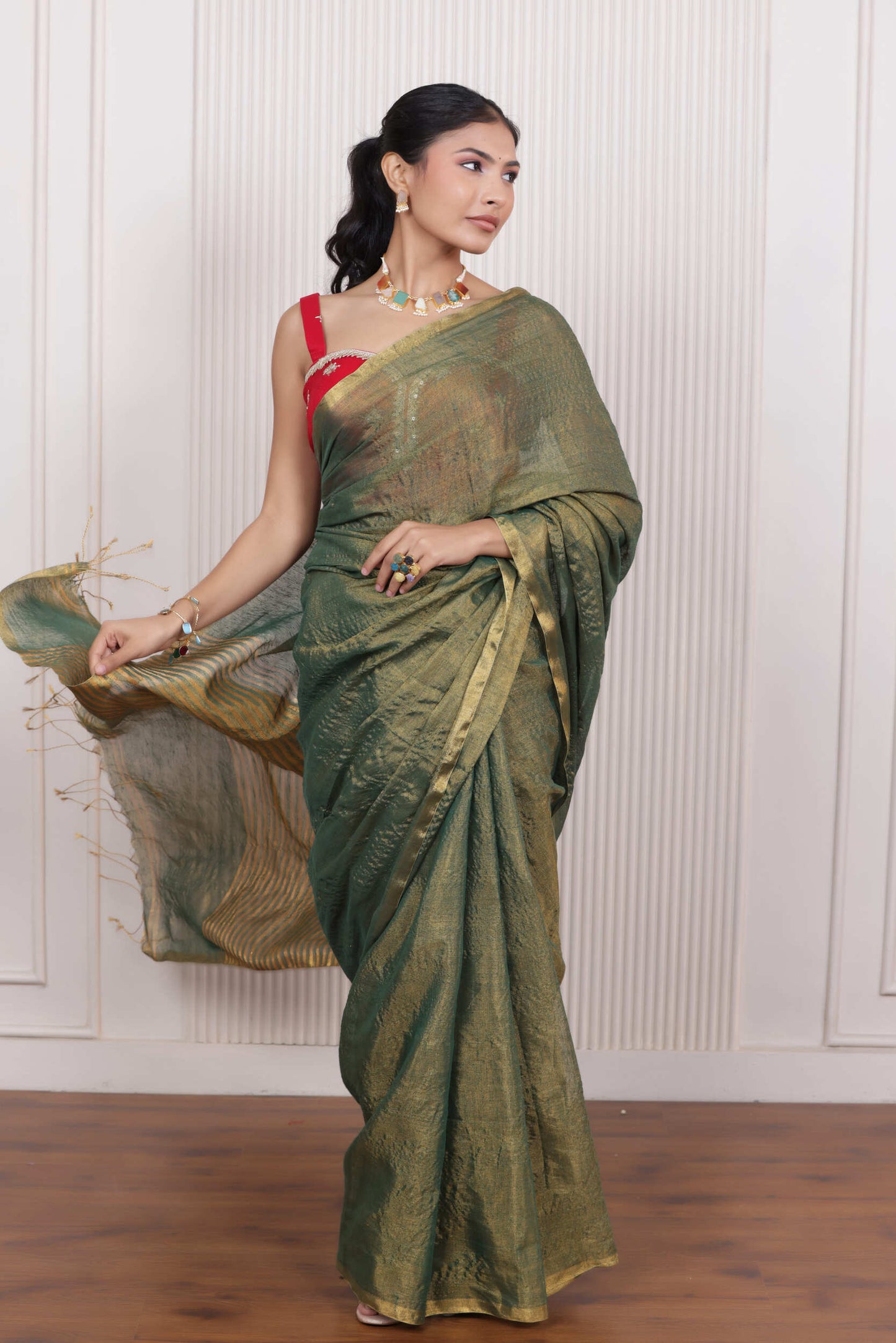 LUXE GREEN LINEN TISSUE SAREE WITH LUSTROUS ZARI STRIPES AND REFINED DRAPE