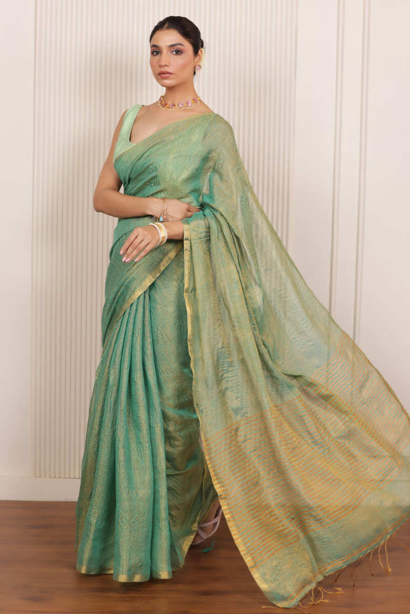 LUXE RAMAR GREEN LINEN TISSUE DRAPE WITH ELEGANT PALLU DETAILING AND LIGHT SHIMMER