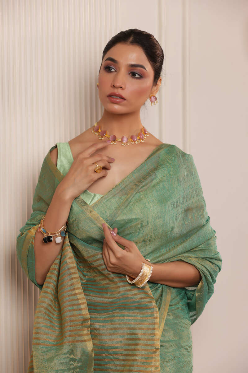 LUXE RAMAR GREEN LINEN TISSUE DRAPE WITH ELEGANT PALLU DETAILING AND LIGHT SHIMMER