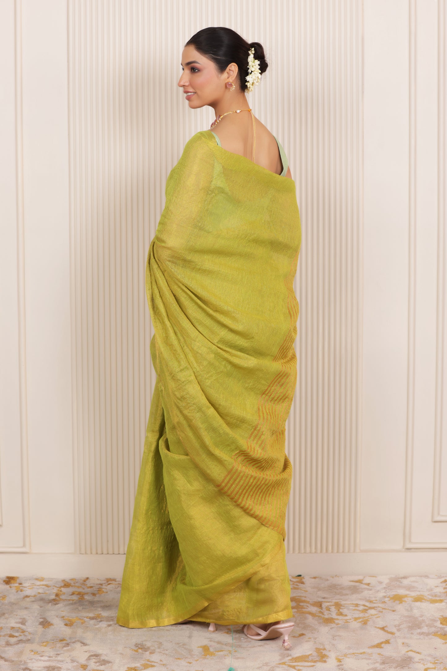 LUXE LIGHT GREEN LINEN SAREE WITH SOFT GOLD HIGHLIGHTS AND FESTIVE FINISH