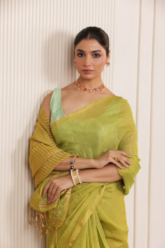 LUXE LIGHT GREEN LINEN SAREE WITH SOFT GOLD HIGHLIGHTS AND FESTIVE FINISH