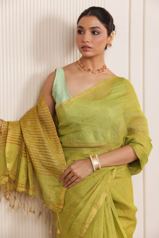 LUXE LIGHT GREEN LINEN SAREE WITH SOFT GOLD HIGHLIGHTS AND FESTIVE FINISH