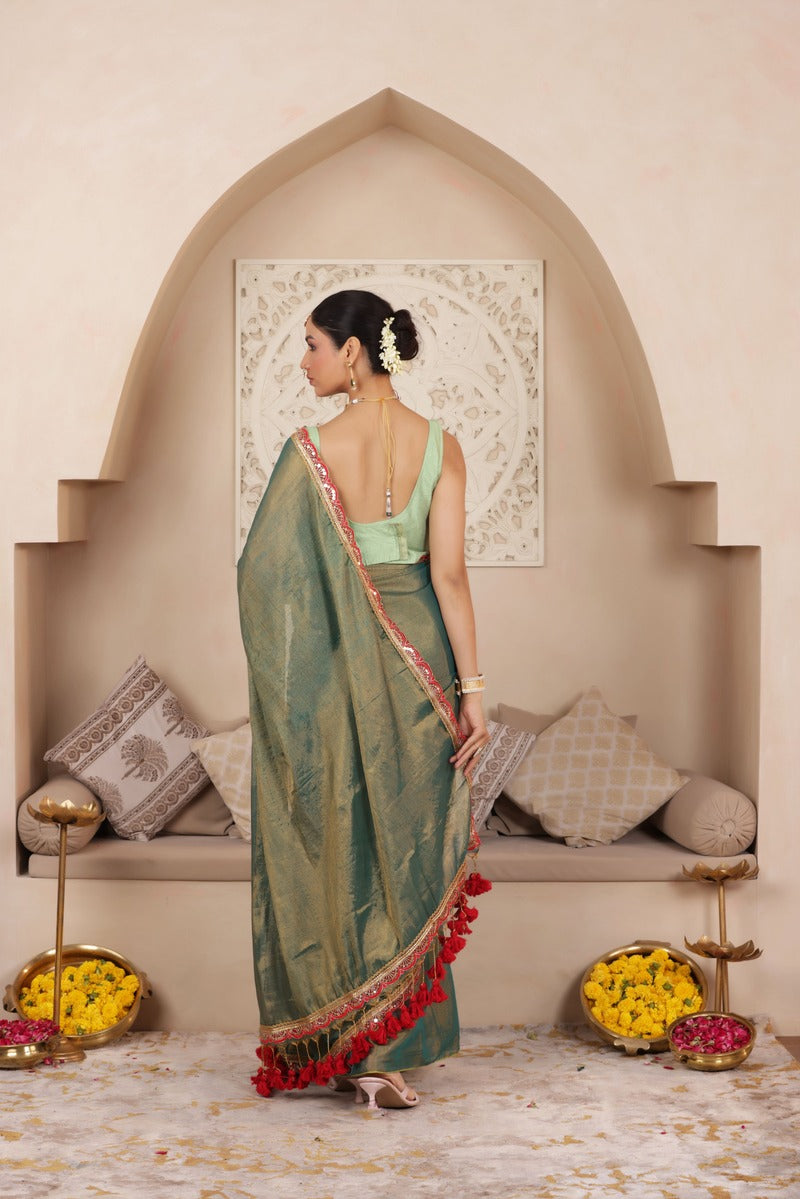GREEN CHARM LUSTROUS TISSUE SAREE WITH REFINED LACE BORDER