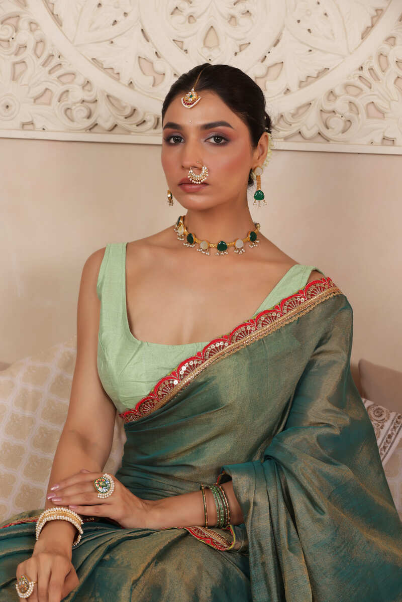 GREEN CHARM LUSTROUS TISSUE SAREE WITH REFINED LACE BORDER